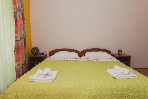 a bed with two towels on top of it at Apartments Lovrić in Vodice