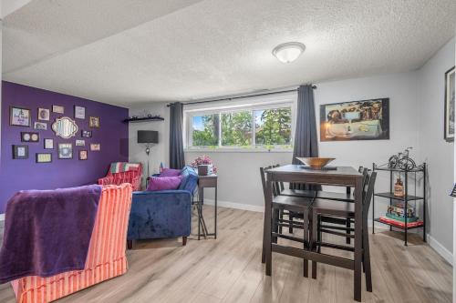 a living room with a blue couch and a table at Modern 3 Bedroom Suite Near Downtown & Stampede Grounds in Calgary