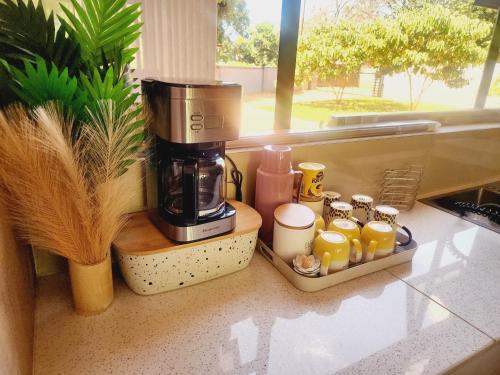 a coffee maker sitting on a counter next to a window at Eastern Road Executive Suites in Harare