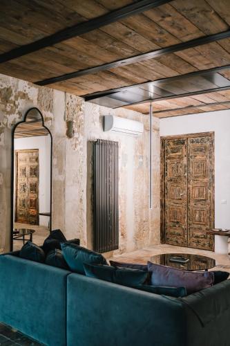 a living room with a blue couch and a table at Il Granile Contemporary Loft in Matera