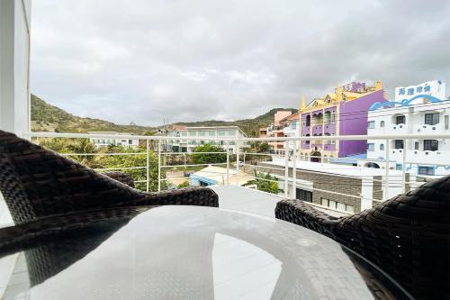 a balcony with chairs and a view of buildings at 初嶼Meet in Hengchun