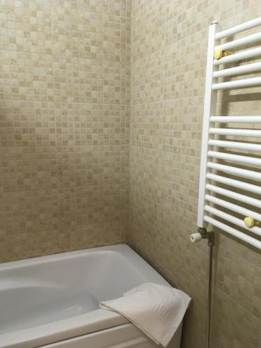a bathroom with a bath tub and a towel at Splendid view Sinaia in Sinaia