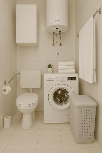 a white bathroom with a toilet and a washing machine at Apartman Ivanto in Makarska
