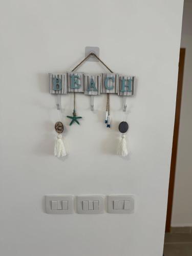 a white wall with a shelf with some lights at 3BR Chalet in MV Ras El Hekma in Ras Elhekma