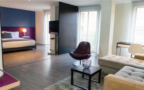 a living room with a bed and a couch at Central Apartamentos Bogotá in Bogotá