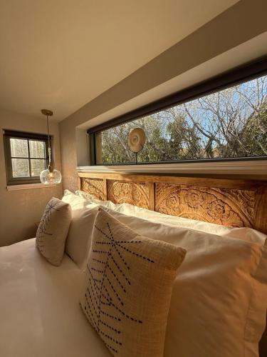 a bedroom with a bed with a large window at Foxglove Cottage in Béal an dá Chab