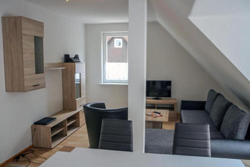 a living room with a couch and a table at Ferienwohnung Lerbachtal L3 in Osterode
