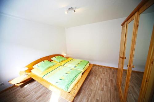 a bedroom with a wooden bed in a room at Ferienwohnung Lerbachtal L3 in Osterode