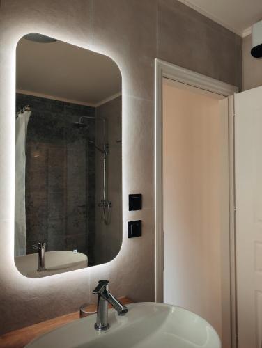 a bathroom with a sink and a mirror at Magnolia Urban Apartments, Corfu Town in Ágios Rókkos