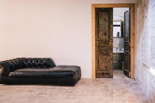 a brown leather couch sitting in a room at Il Granile Contemporary Loft in Matera