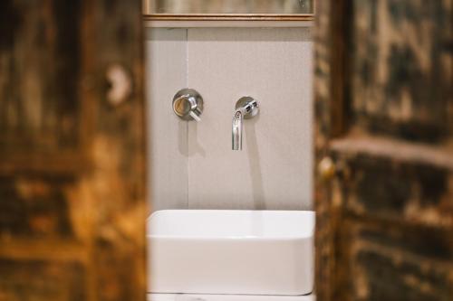 a bathroom with a sink and a faucet at Il Granile Contemporary Loft in Matera