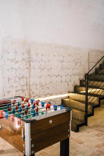 a foosball table in a room with stairs at Il Granile Contemporary Loft in Matera
