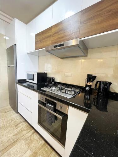 a kitchen with a stove and a microwave at Ocean view & sunset in the heart of Rabat 2 in Rabat