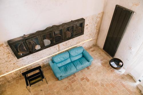 an overhead view of a blue couch in a room at Il Granile Contemporary Loft in Matera