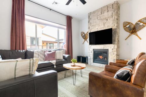 a living room with a couch and a fireplace at Adora in the Pines with Axe Throwing in Flagstaff