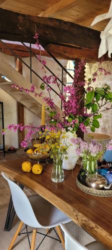 a wooden table with flowers in vases on it at Villa Bakola in Sívros