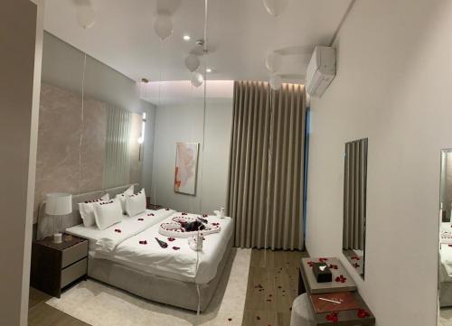 a bedroom with a large bed and a mirror at Liora ليورا in Riyadh