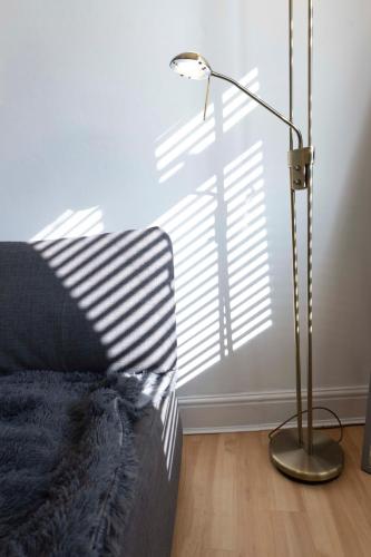 a lamp sitting next to a bed in a room at The Loft Apartment in Shoreham-by-Sea