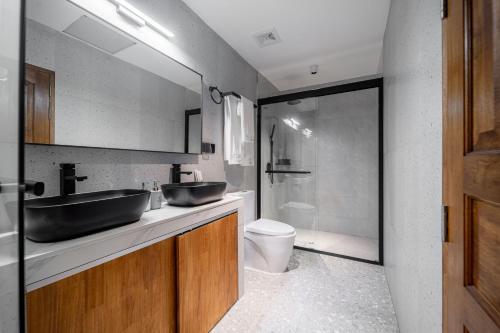 a bathroom with two sinks and a toilet at Oasis Dhigurah in Dhigurah