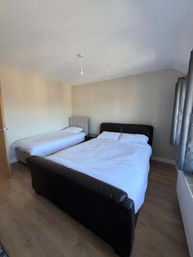 a bedroom with two beds and a couch in it at Dudley, Birmingham and Wolverhampton Contractor and Family Stay B69 in Dudley