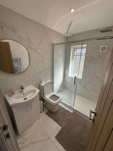 a bathroom with a shower and a toilet and a sink at Dudley, Birmingham and Wolverhampton Contractor and Family Stay B69 in Dudley
