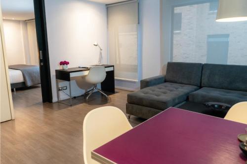 a living room with a couch and a table at Central Apartamentos Bogotá in Bogotá