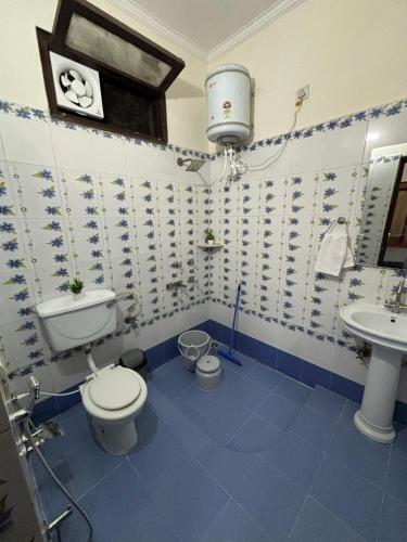 a bathroom with a toilet and a sink at Whispers of Peace Villa in Amritsar