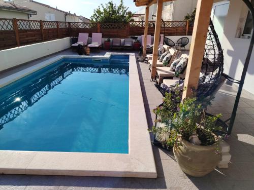 a swimming pool on a patio with a house at B&B Buzolic 1 Hvar in Hvar