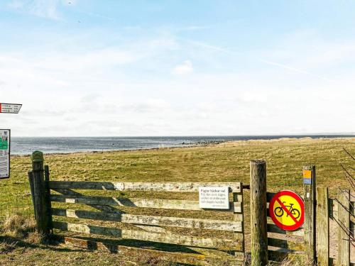 a fence with a sign on it next to a beach at 4 star holiday home in SKÅNE VEJBYSTRAND in Vejbystrand