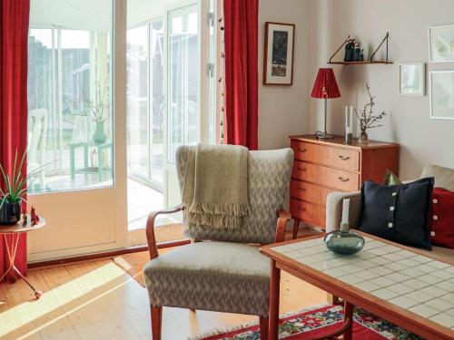 a living room with a chair and a table at 4 star holiday home in SKÅNE VEJBYSTRAND in Vejbystrand