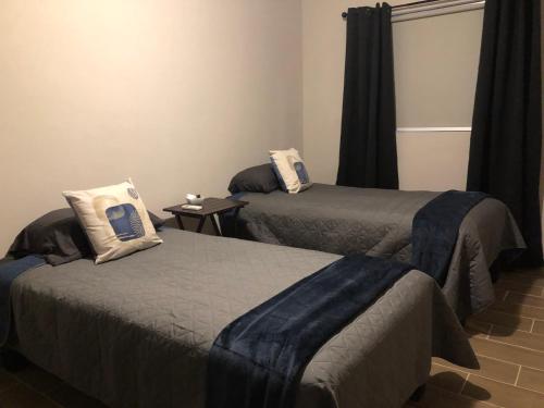 a room with two beds with pillows on them at LiV109 Norte Depa 3 in Cd Obregon in Ciudad Obregón