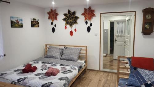 a bedroom with a bed and some decorations on the wall at Agroturystyka Przy Rajskim Sadzie in Nowy Berezów