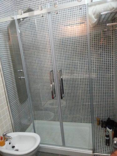 a bathroom with a shower with a toilet and a sink at Armador Apartment in Armação de Pêra