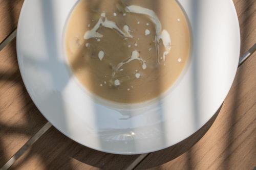 a cup of coffee on a plate on a table at Oasis Dhigurah in Dhigurah