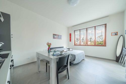 a dining room with a table and a window at Einstein - Modern Apartment with Balcony in Somma Lombardo