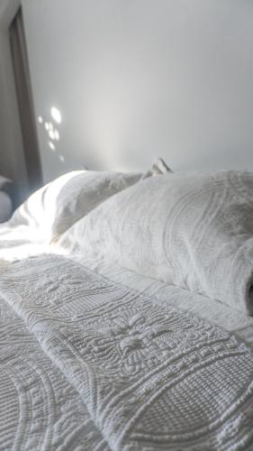 an unmade bed with a white blanket on it at Valle Bonito in Los Mochis
