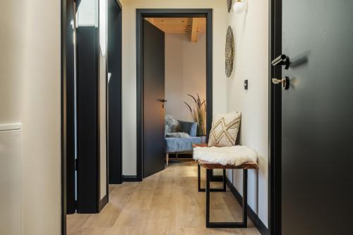 a hallway with a door leading to a living room at Chalet Bergblick Suites - Luxury Escape in Bad Kleinkirchheim