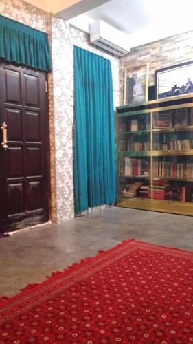 a room with two doors and a red rug at Serayu Brawijaya in Jenggrik