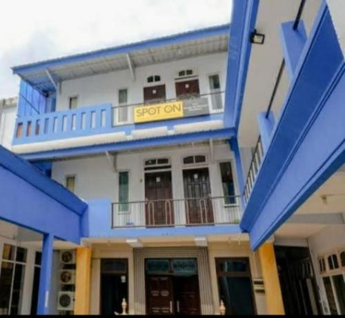 a building with a sign that reads stop on at Serayu Brawijaya in Jenggrik