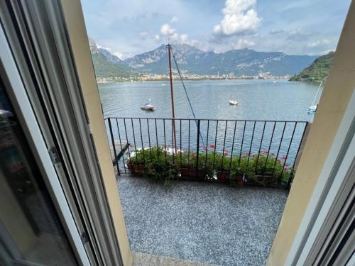 a balcony with a view of a body of water at Luxury in Lake Como in a 5 bed lake front home in Valmadrera