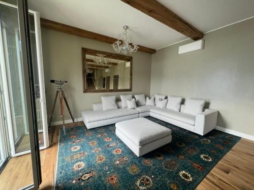 a living room with white couches and a rug at Luxury in Lake Como in a 5 bed lake front home in Valmadrera