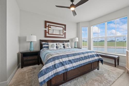 a bedroom with a bed and a large window at Golf Condo Views With Resort Pool and Amenities in Naples