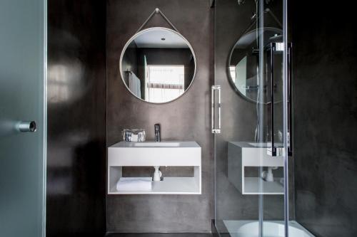 a bathroom with two sinks and a mirror at Aparthotel Allada 3* in Barcelona