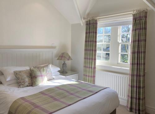 a bedroom with a bed and a window at The Sportsman's Arms in Harrogate