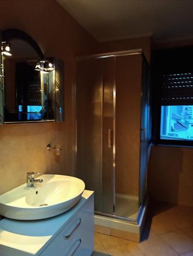 a bathroom with a sink and a shower at Golden Apartment in Tirana