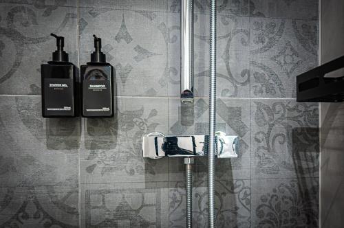 a shower with two bottles ofodorizers on a wall at Valletta Collection Orangerie 401 in Valletta