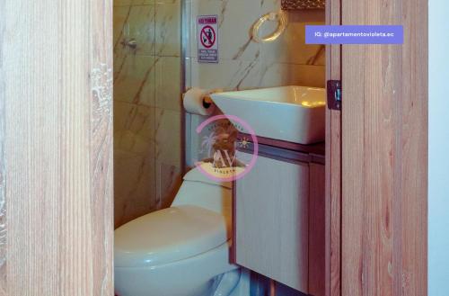 a small bathroom with a toilet and a sink at Apartamento Violeta con Impresionante Vista al Mar in Playas