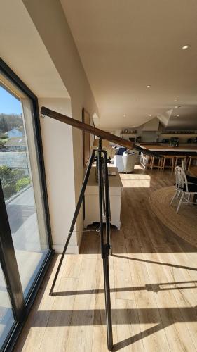 a tripod in a room with a large window at Chupra in Saint Mawes