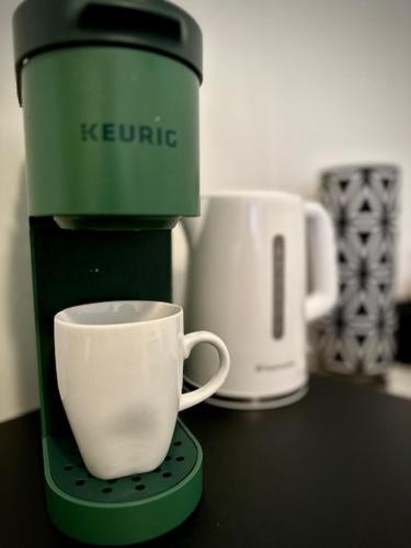 a coffee maker with a cup on a counter at Girls Night Out in Toronto