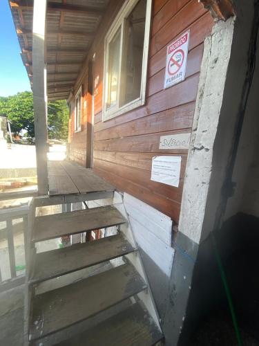 a building with stairs leading up to a window at Hostel Pousada B&B em Itajai in Itajaí